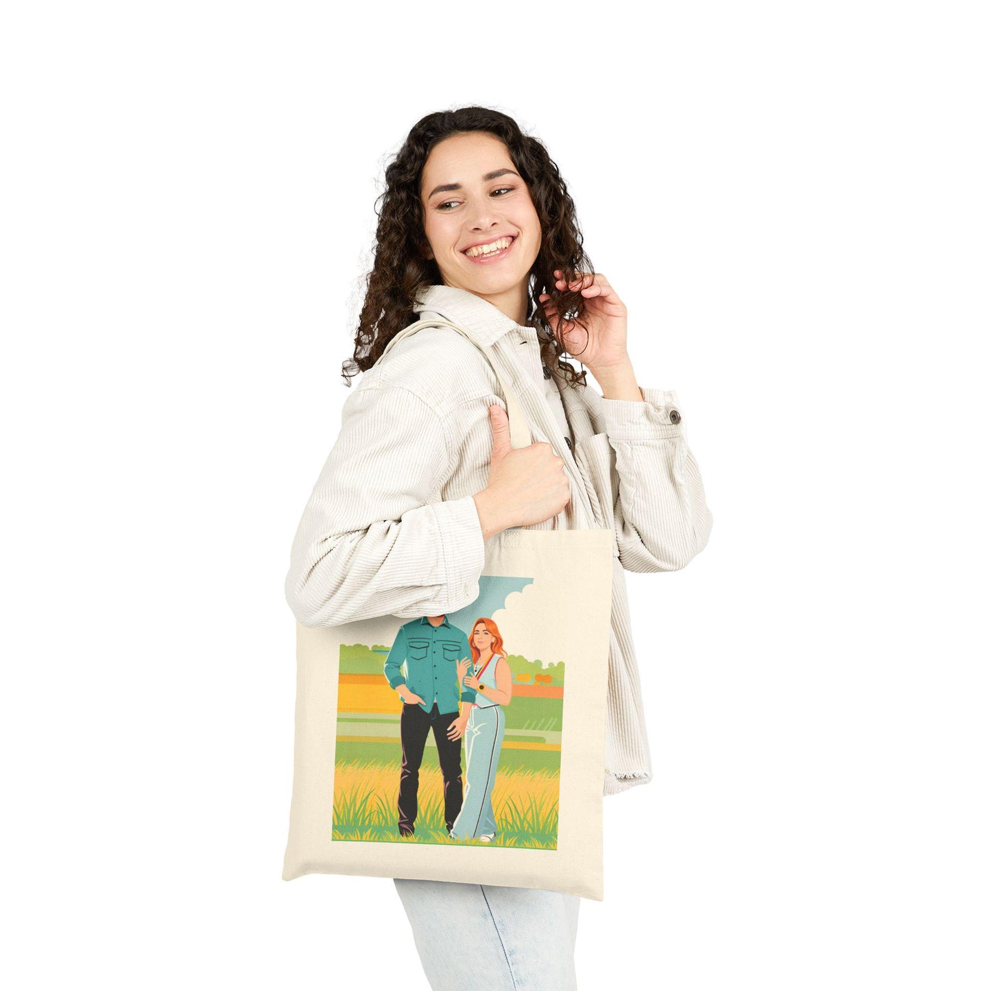 Woman holding a tote bag with a graphic design on a white background