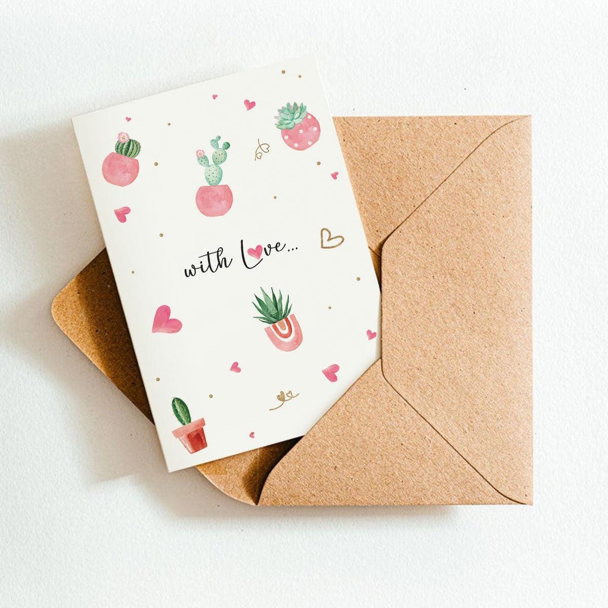 Greeting card with cactus illustrations and 'with Love' text, placed inside a brown envelope on a white background.