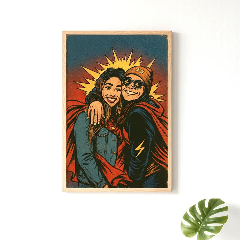 Framed artwork of a couple embracing with a sunburst background on a white wall.