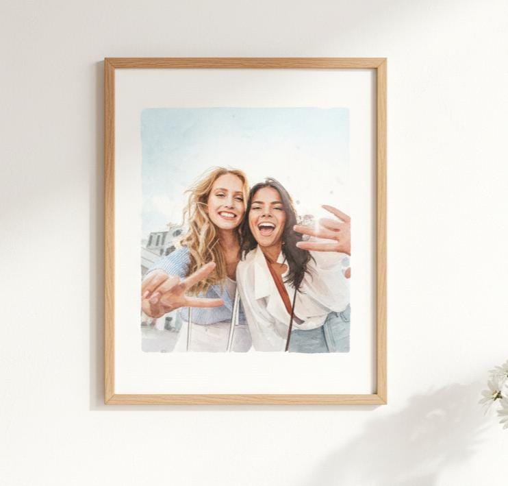 Framed photo of two women taking a selfie on a white wall