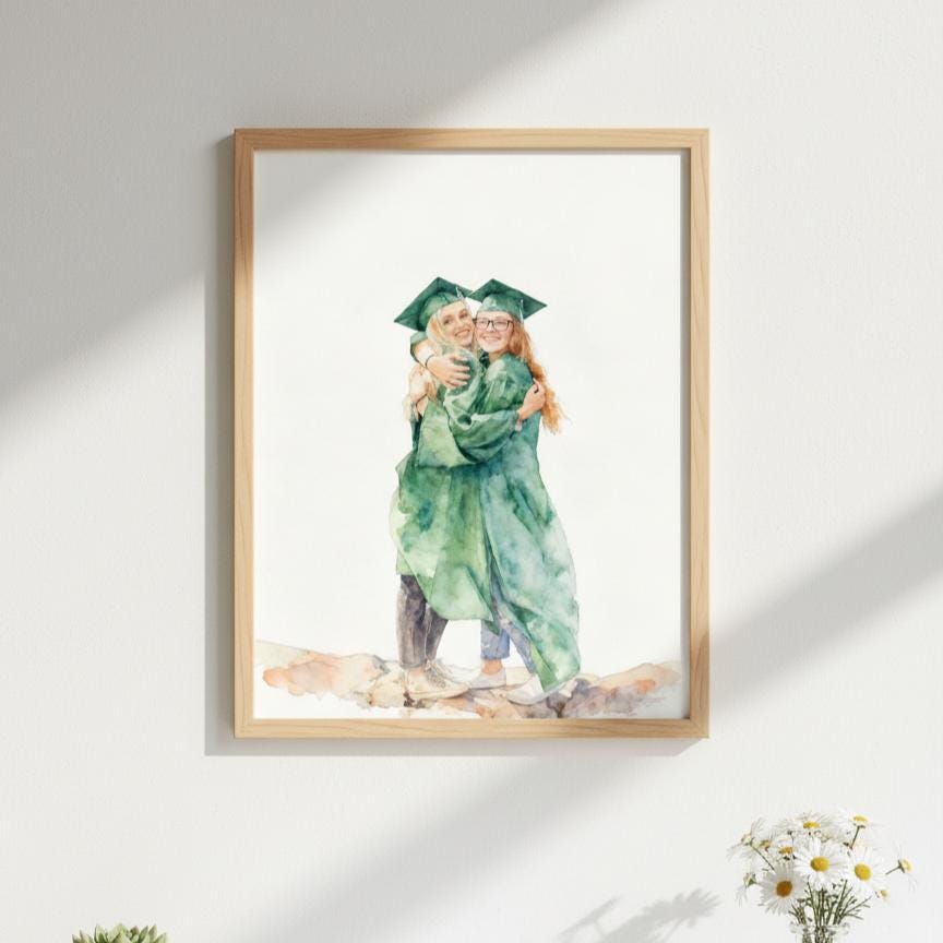 Framed artwork of two people in graduation attire embracing on a white wall.