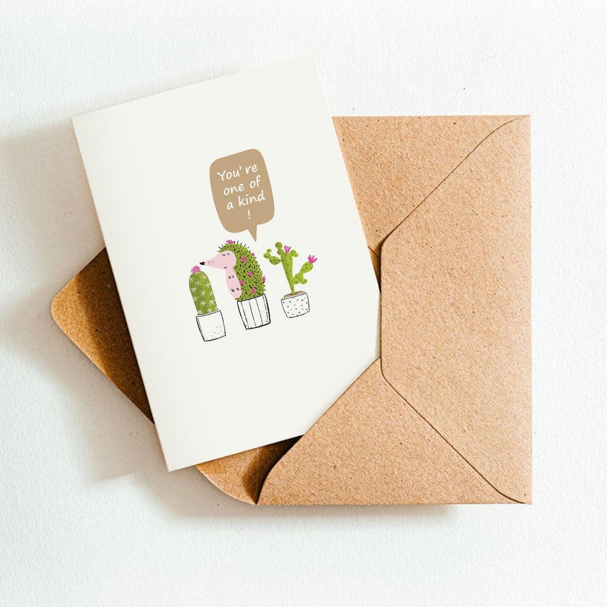 Greeting card with cactus illustrations and a brown envelope on a white background