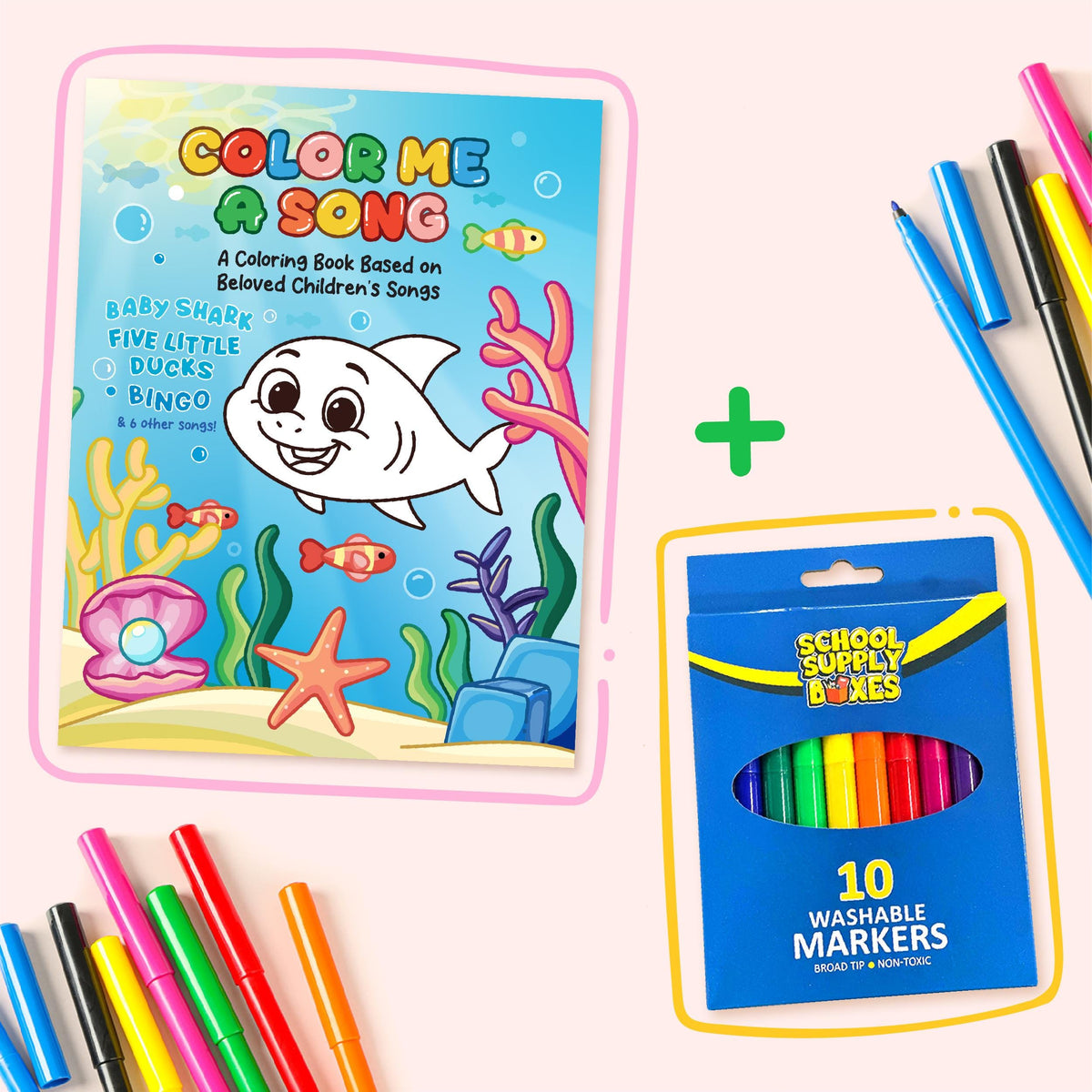 Coloring book titled 'Color Me a Song' with a shark illustration, surrounded by washable markers on a light pink background.