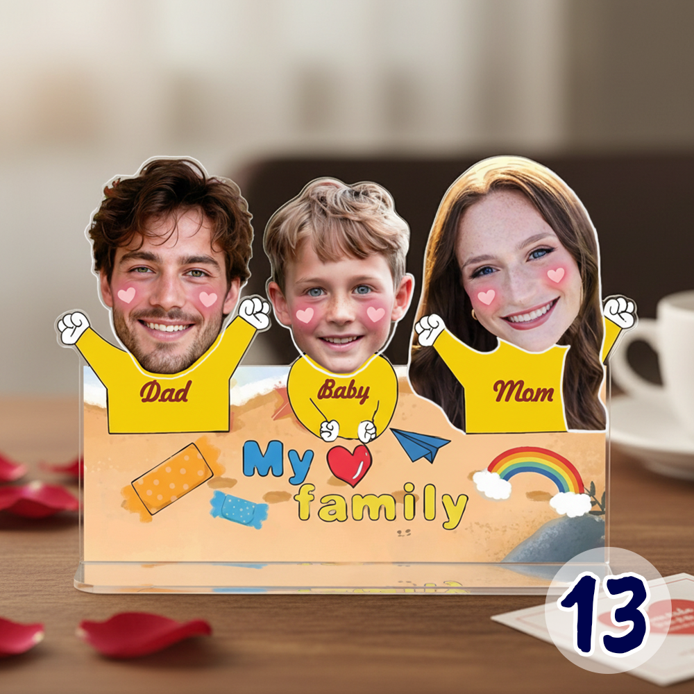 Personalized family bobblehead standee with custom faces labeled Mom, Dad, and Baby on acrylic base