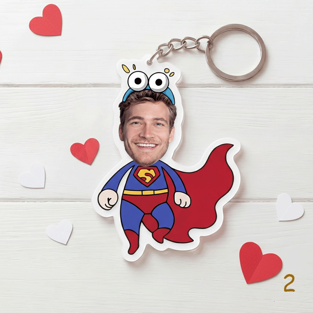 Superhero-themed keychain with a person's face printed on it, on a light wooden surface