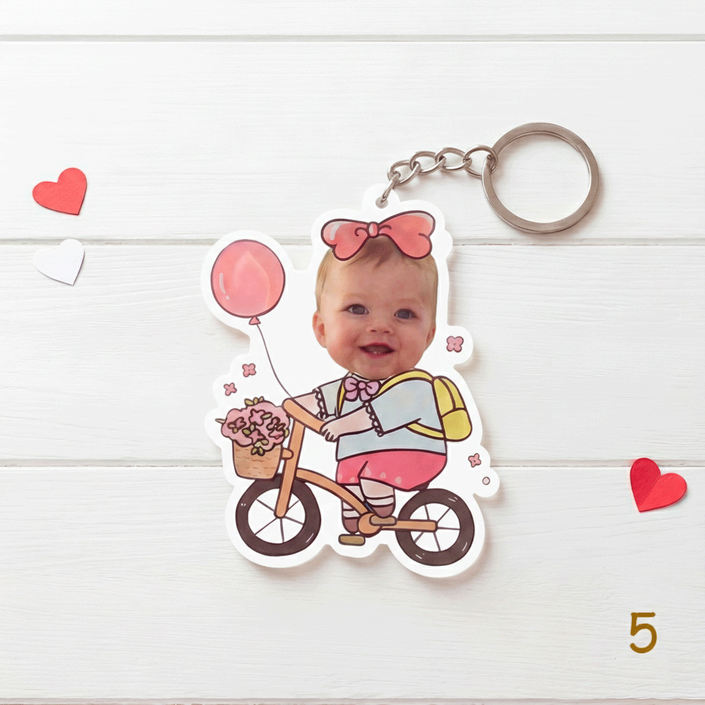 Keychain with a child riding a bike design on a white background