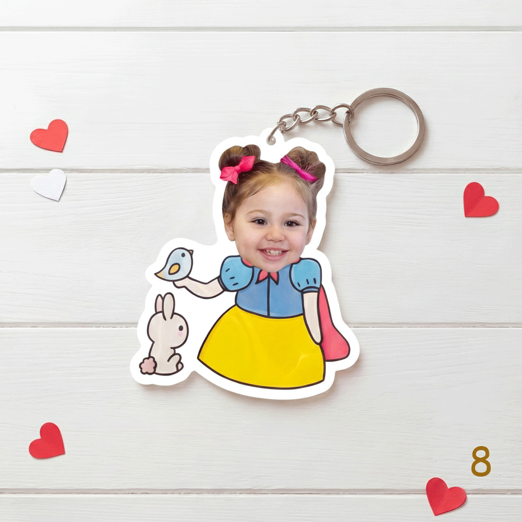 Keychain with a cartoon character design on a wooden surface with heart decorations.