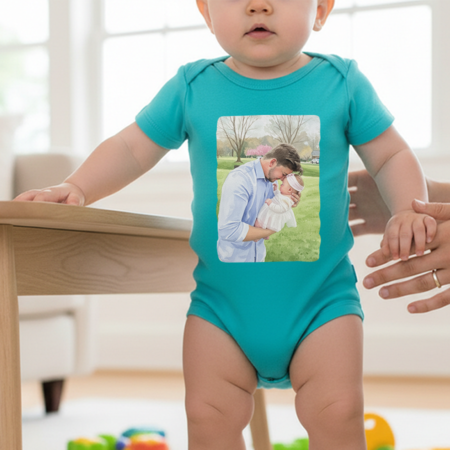 Baby wearing a teal onesie with a printed image of a man and child, standing at a table.