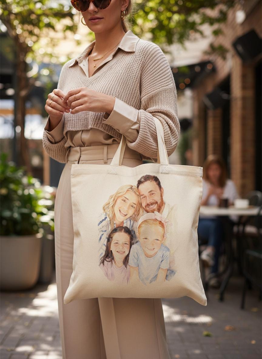 Person holding a tote bag with a family illustration outdoors.
