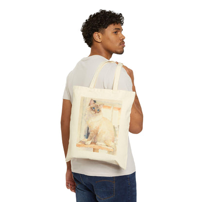 Man carrying a tote bag with a cat design on a white background