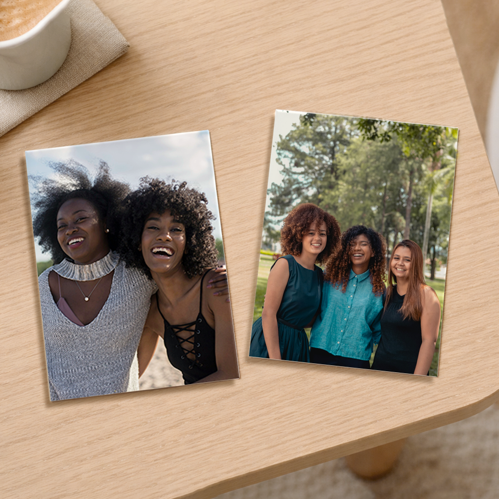 Personalized photo magnets with printed images of friends, placed on a wooden table