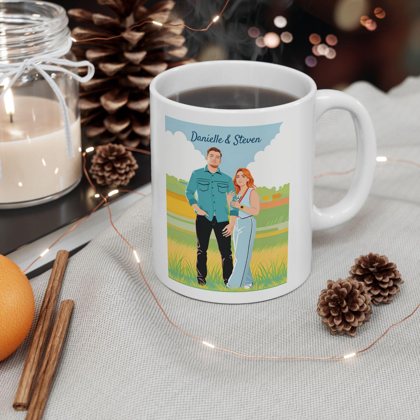 White mug with a printed design of a couple in a field, surrounded by decorative items like a candle, cinnamon sticks, and pine cones.