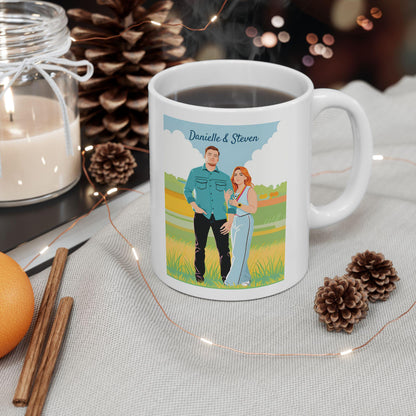 White mug with a printed design of a couple in a field, surrounded by decorative items like a candle, cinnamon sticks, and pine cones.