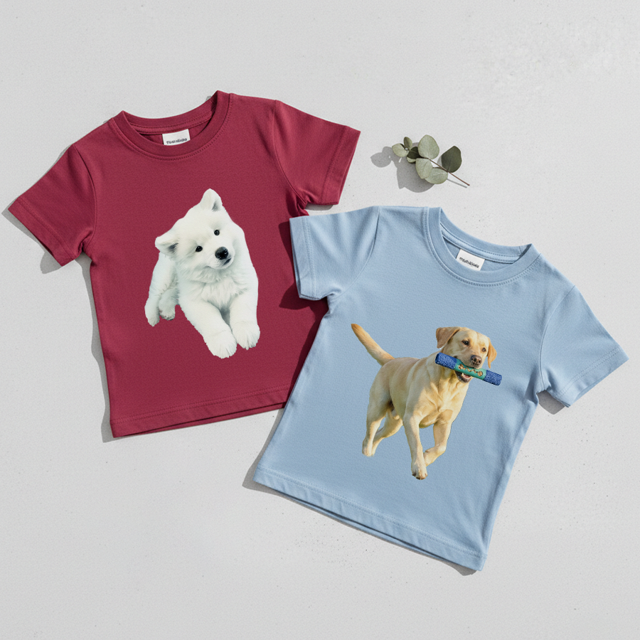 Two children's t-shirts with dog illustrations on a light gray background