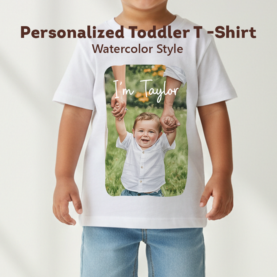 Child wearing a white t-shirt with a photo of a child holding hands and text 'I'm Taylor' on a plain background.