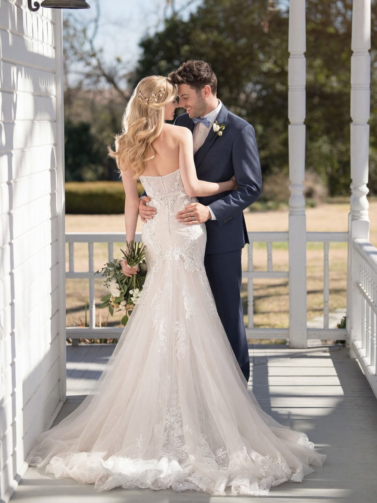 Couple embracing on a porch with a scenic background